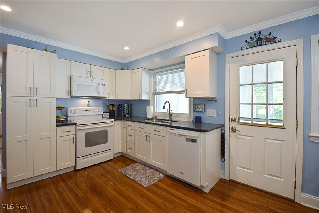 1388 Ford Road Lyndhurst, OH 44124 - Photo 7 of 39 Kitchen featuring hardwood / wood-style flooring, white appliances, and white cabinets