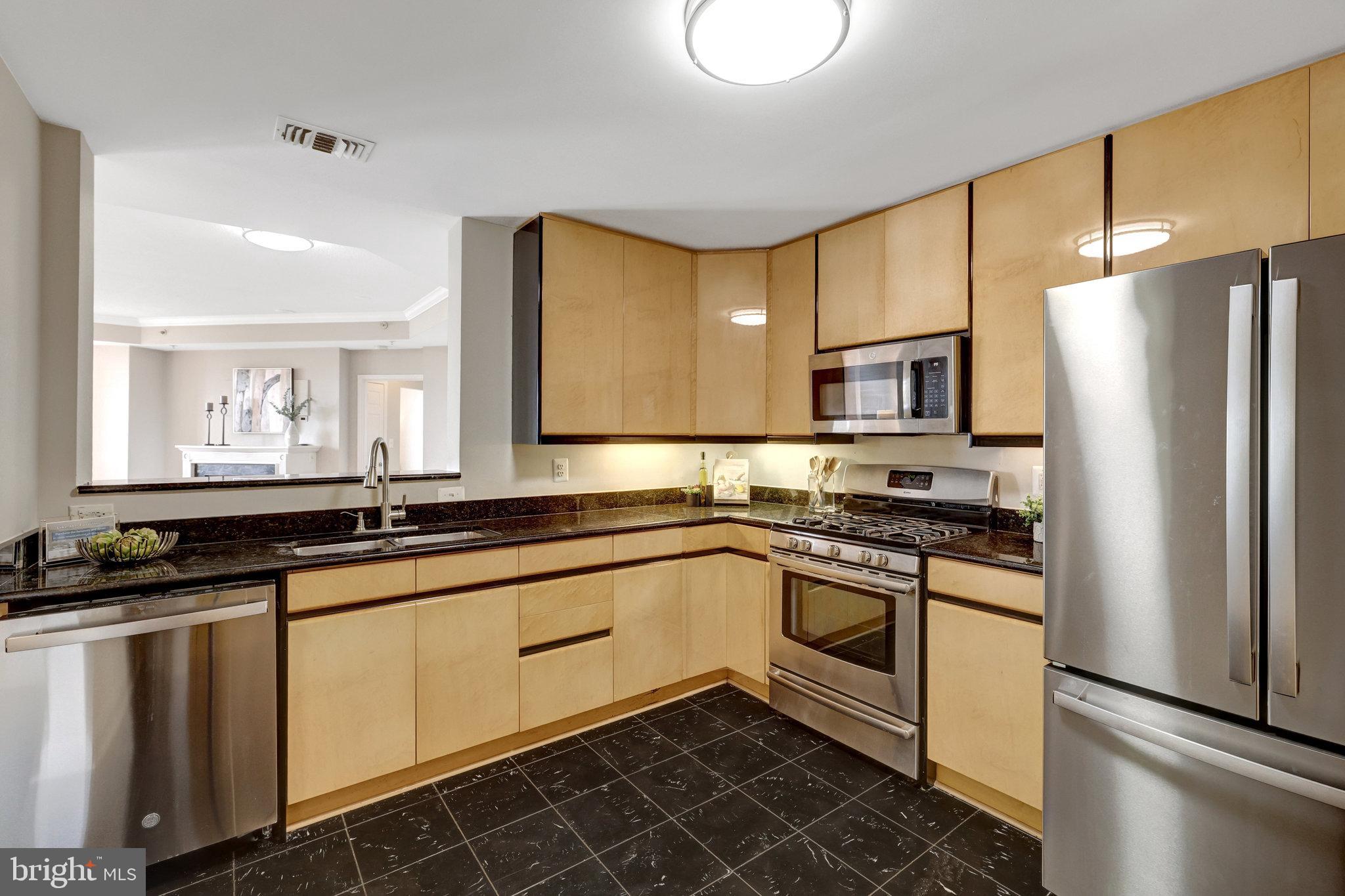 11776 Stratford House Place, Unit 601 Reston, VA 20190 - Photo 11 of 58 a kitchen with stainless steel appliances a stove sink and refrigerator