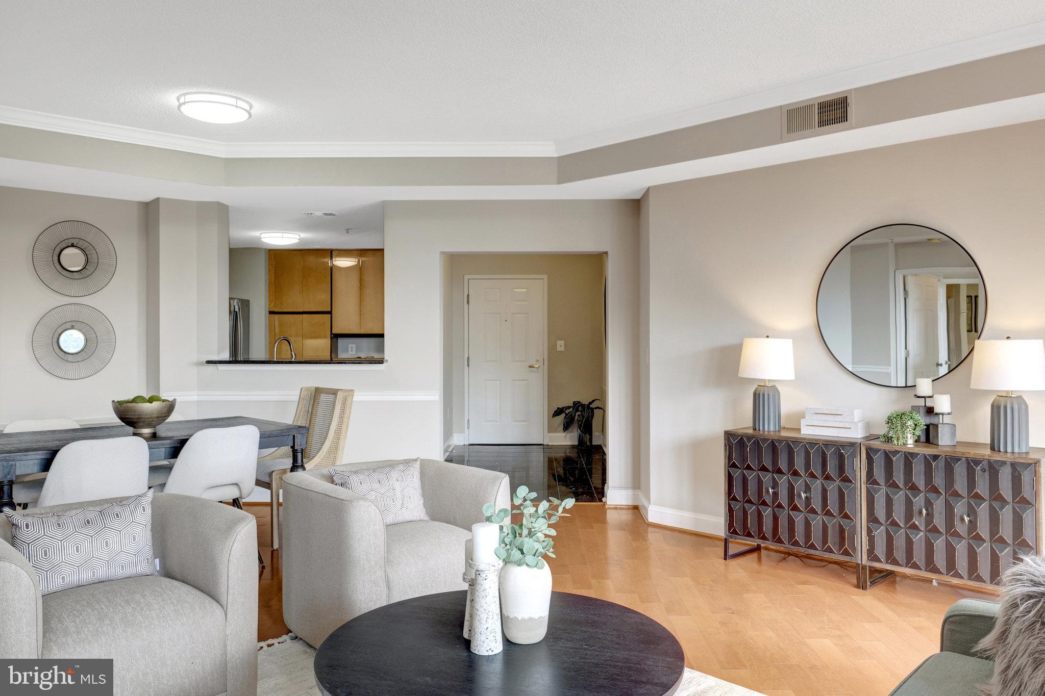 11776 Stratford House Place, Unit 601 Reston, VA 20190 - Photo 13 of 58 a living room with furniture a mirror and a large window