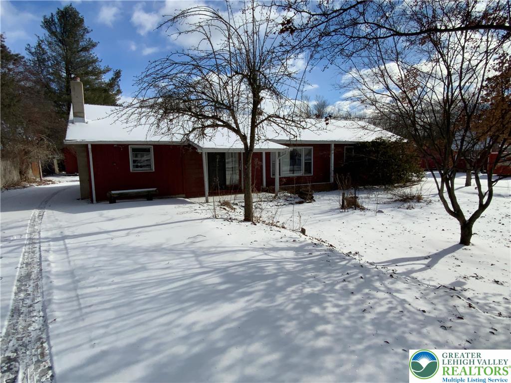 a view of a house with snow on the road