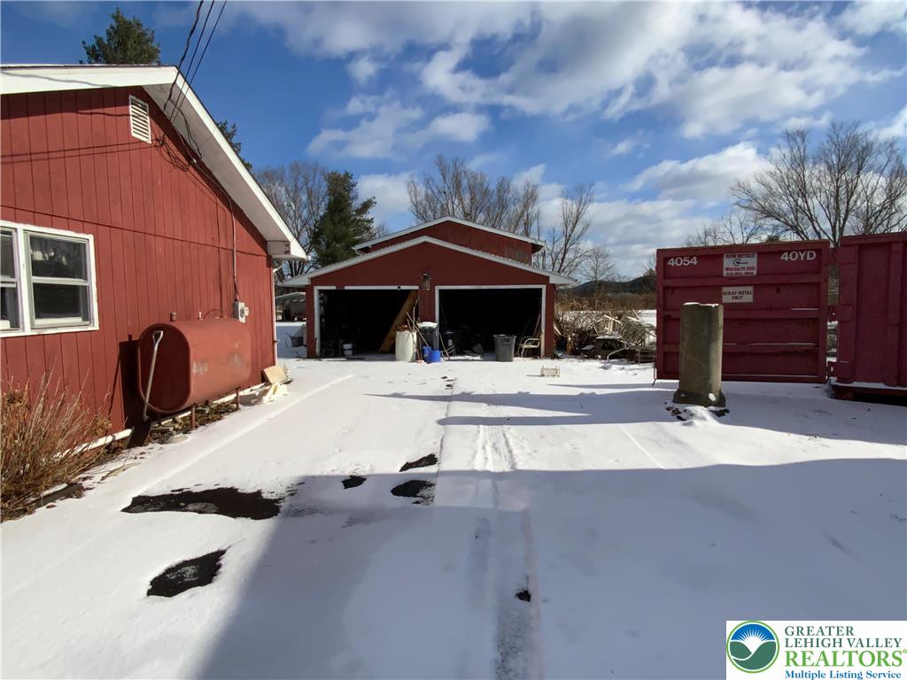 580 Gilbert Road Gilbert, PA 18331 - Photo 3 of 11 a patio with a table and chairs under an umbrella