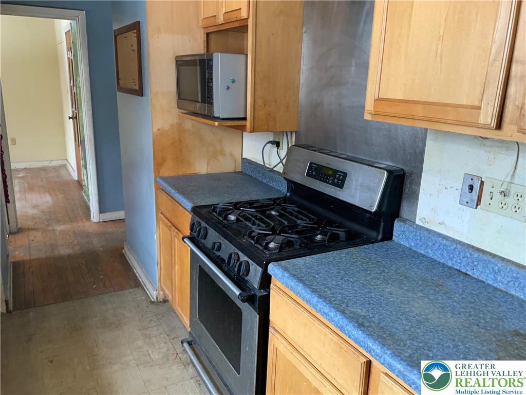 580 Gilbert Road Gilbert, PA 18331 - Photo 7 of 11 a kitchen with stainless steel appliances granite countertop a stove a sink and a microwave
