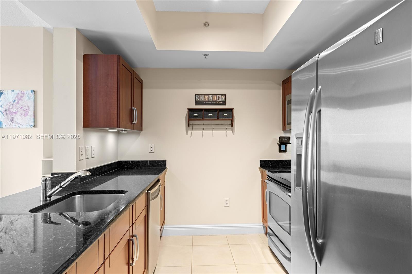 7275 Southwest 90th Way, Unit 404 Miami, FL 33156 - Photo 14 of 35 a kitchen with a refrigerator and a sink