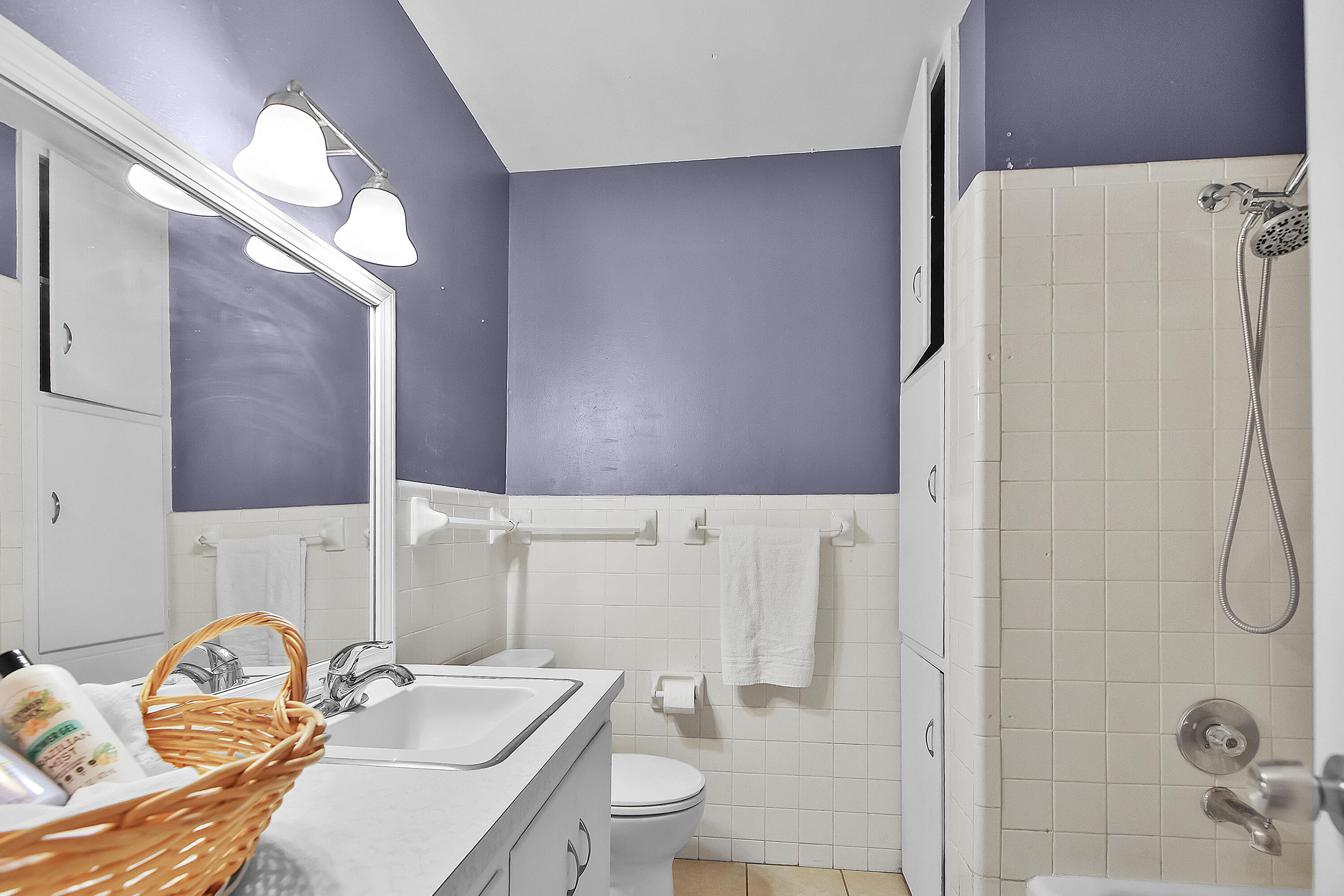 4513 48th Street Lubbock, TX 79414 - Photo 16 of 55 a bathroom with a sink a toilet and a mirror