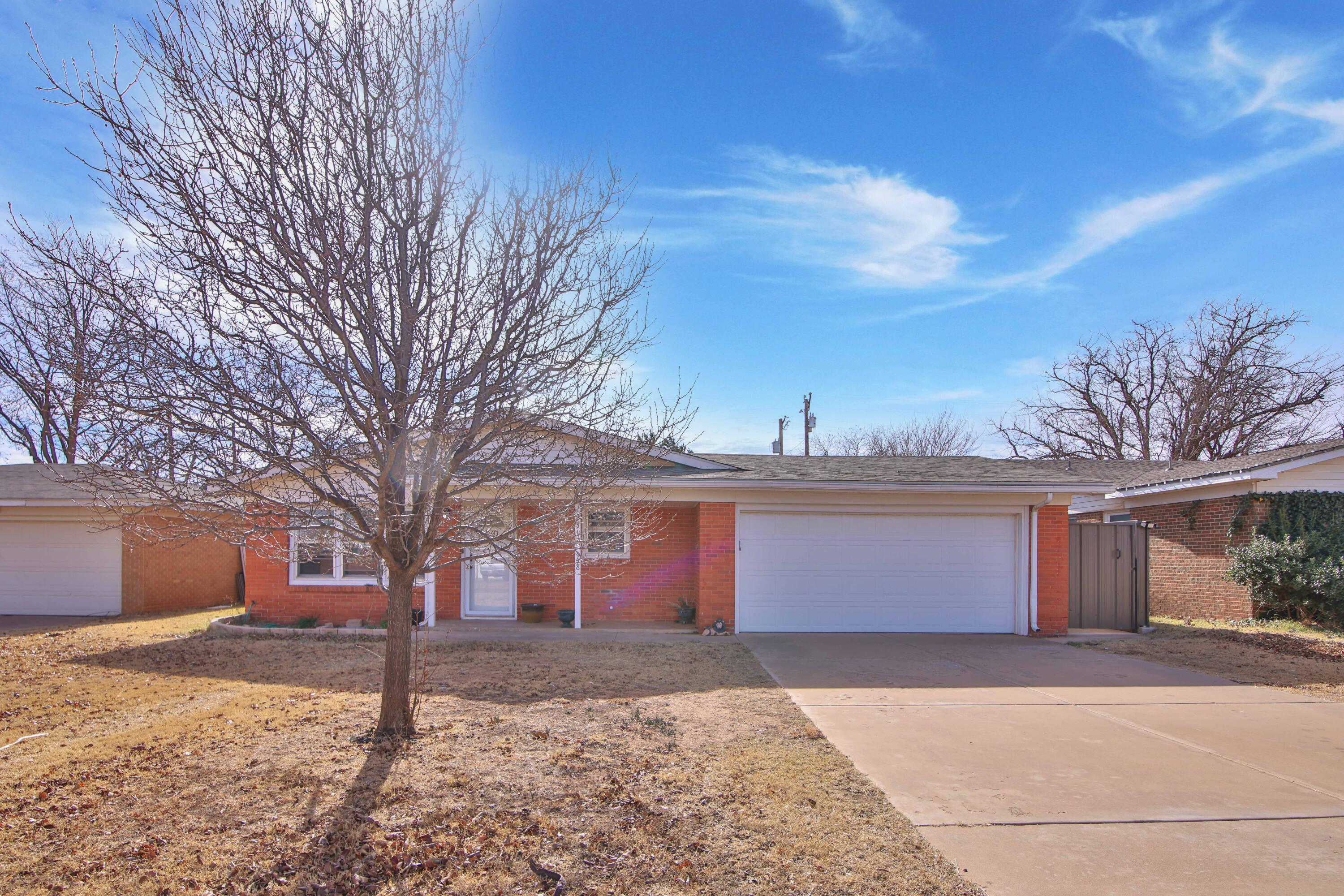 4513 48th Street Lubbock, TX 79414 - Photo 2 of 55 a front view of a house with a yard