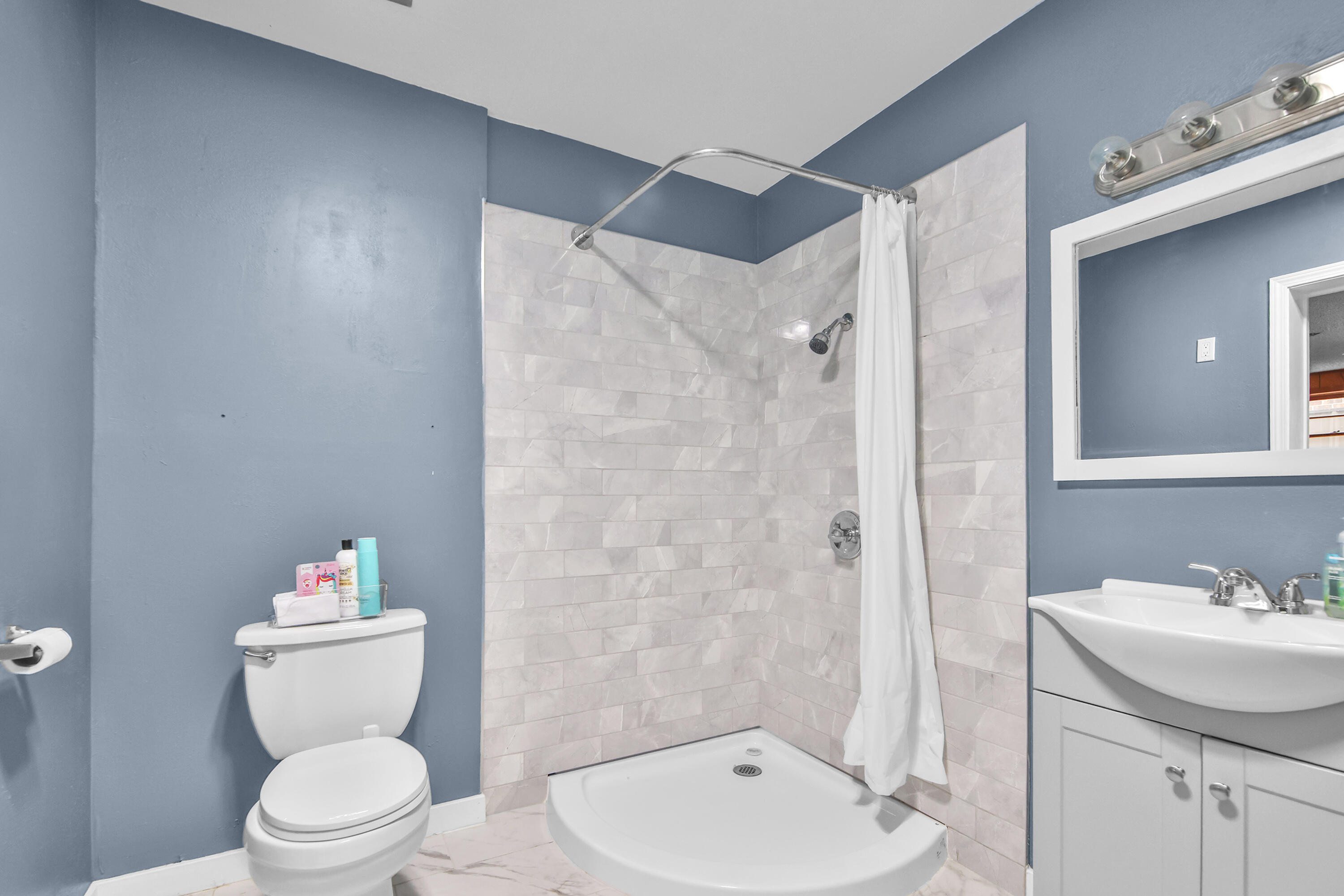 4513 48th Street Lubbock, TX 79414 - Photo 24 of 55 a bathroom with a toilet sink and a mirror