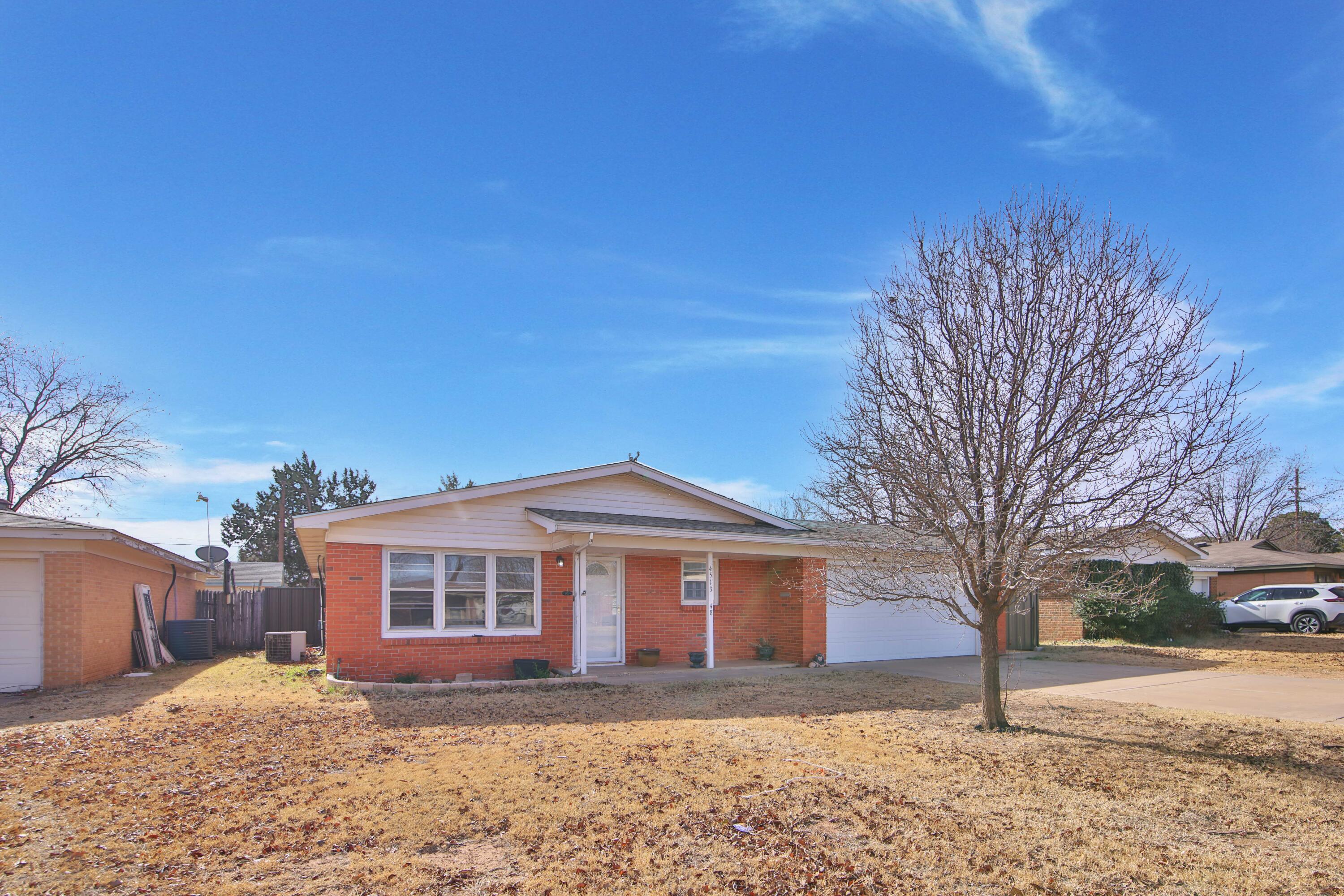 4513 48th Street Lubbock, TX 79414 - Photo 3 of 55 a front view of a house with a yard