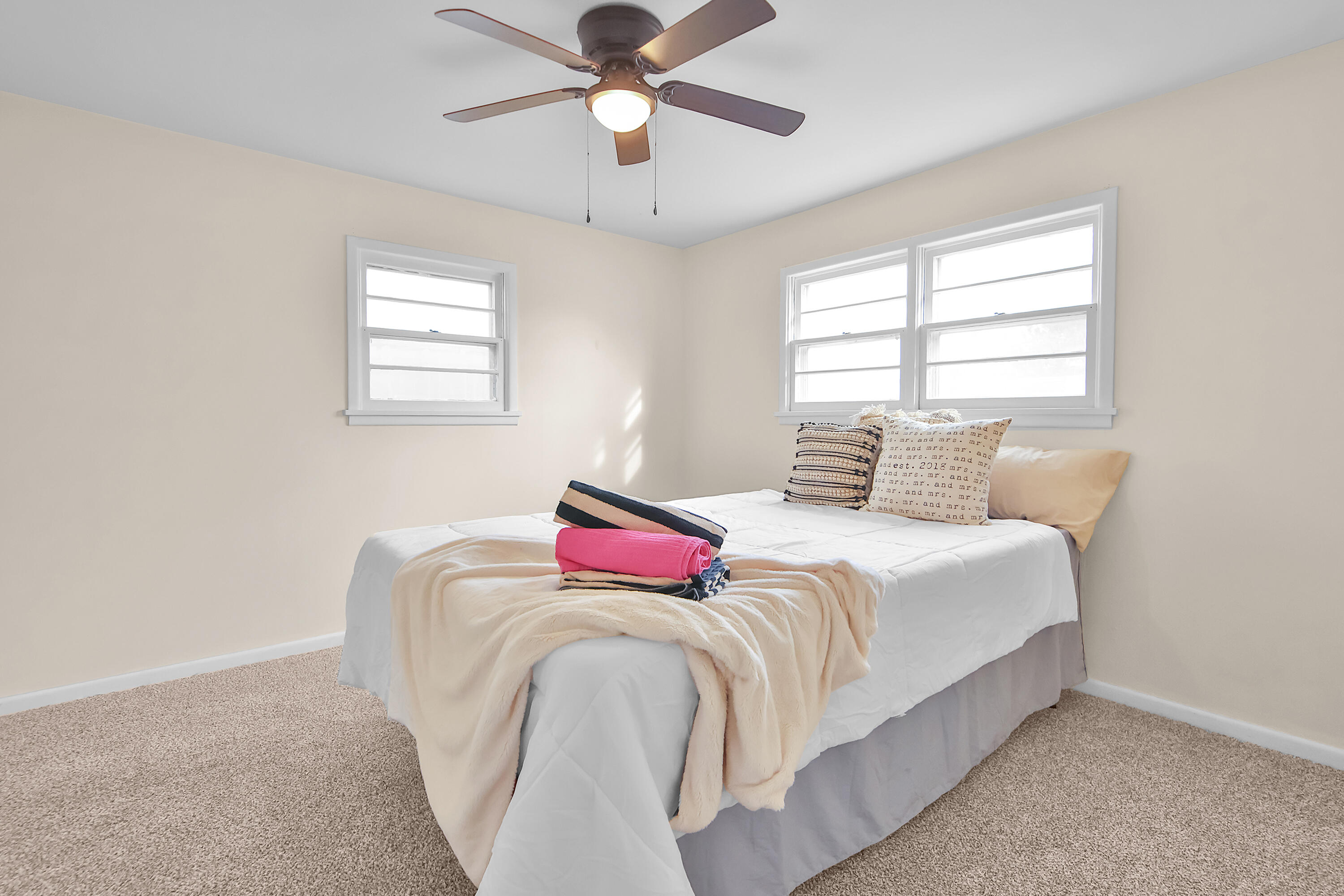 4513 48th Street Lubbock, TX 79414 - Photo 10 of 55 a bedroom with a bed and a chandelier