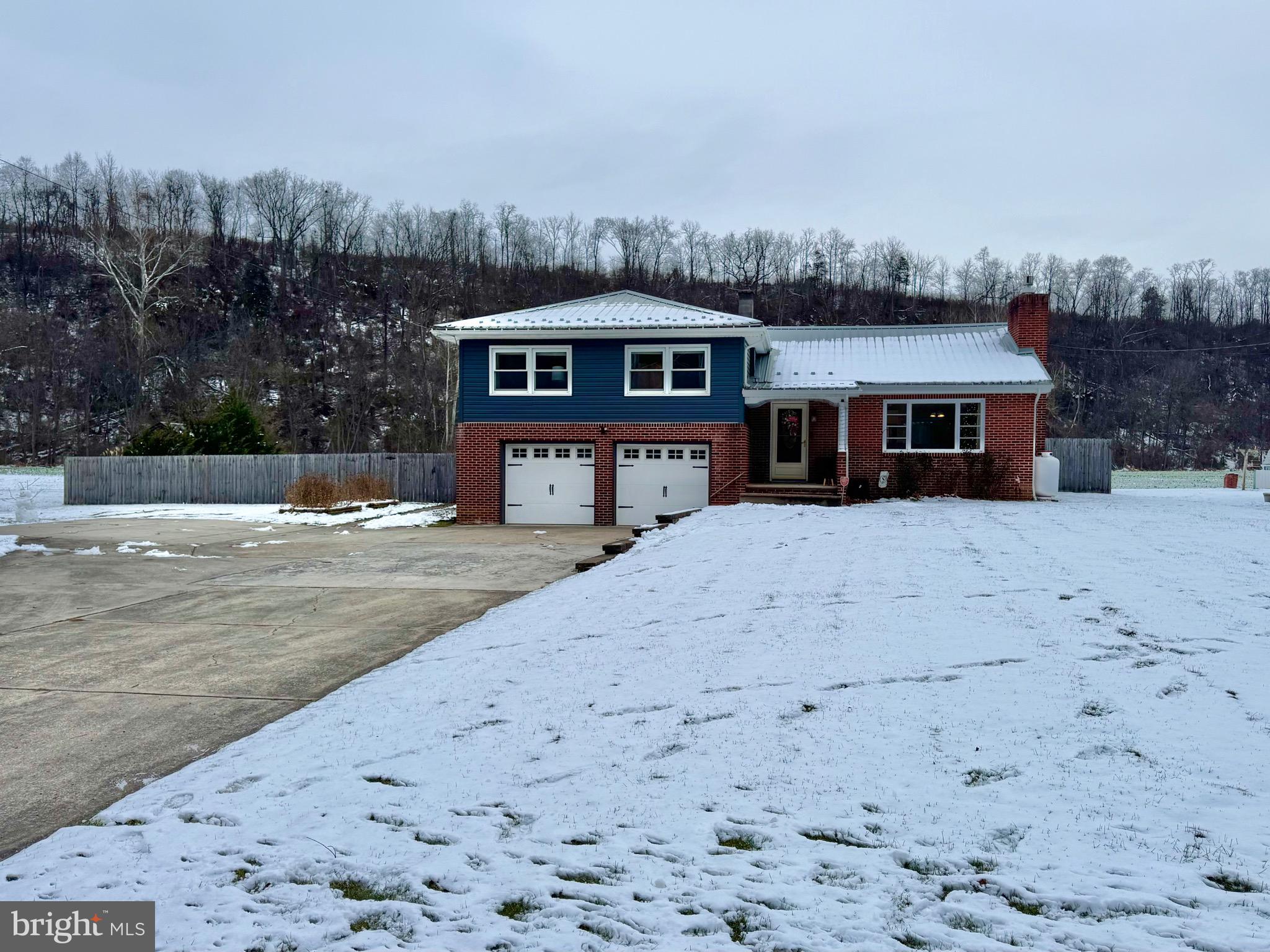 699 Honey Creek Road Reedsville, PA 17084 - Photo 23 of 26 a front view of a house with a yard covered with snow