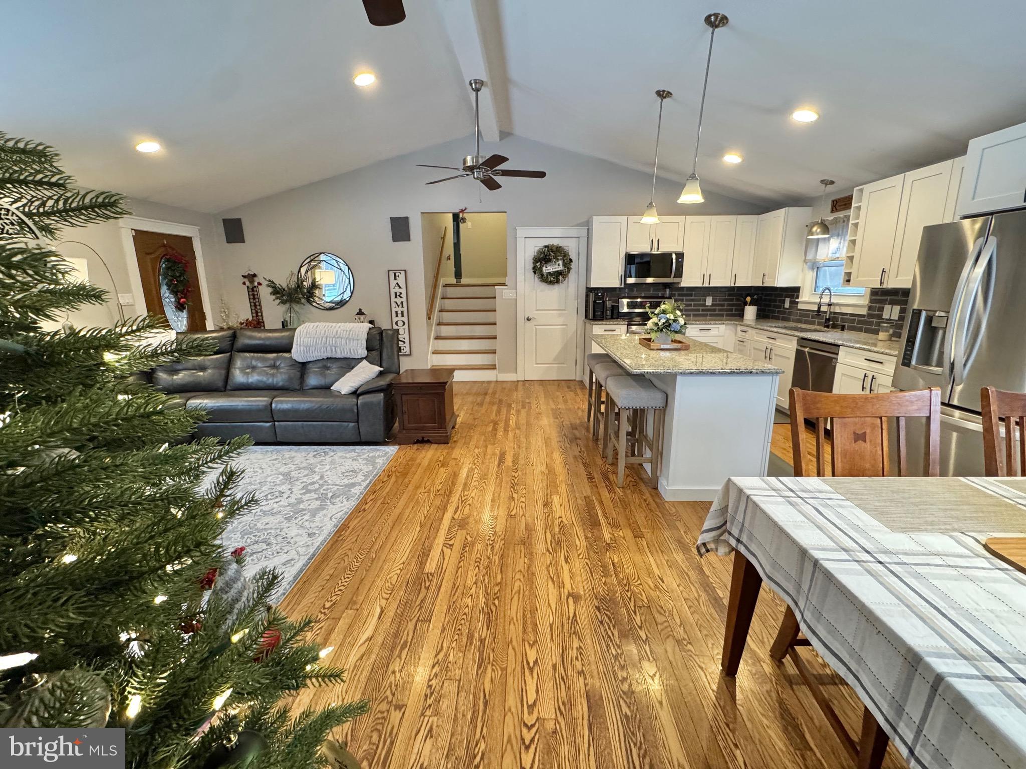699 Honey Creek Road Reedsville, PA 17084 - Photo 7 of 26 a living room with stainless steel appliances kitchen island granite countertop furniture wooden floor and a view of kitchen