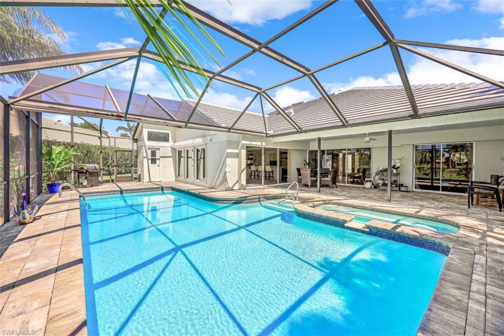 2016 Duke Drive Naples, FL 34110 - Photo 18 of 23 a view of a swimming pool with a patio