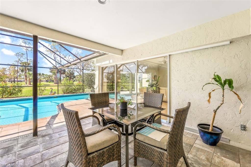 2016 Duke Drive Naples, FL 34110 - Photo 20 of 23 a view of a dining room with furniture wooden floor and chandelier