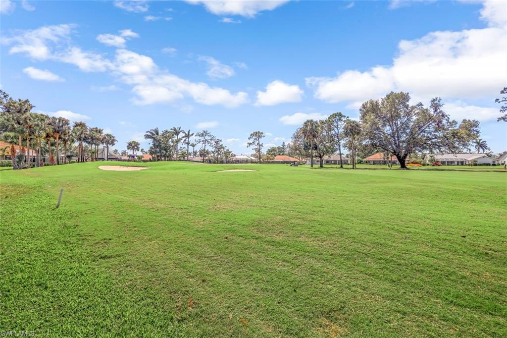 2016 Duke Drive Naples, FL 34110 - Photo 21 of 23 a view of a big yard with lots of green space and fog