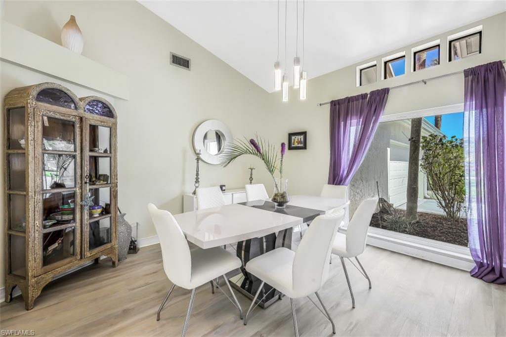 2016 Duke Drive Naples, FL 34110 - Photo 4 of 23 a view of a dining room with furniture window and wooden floor