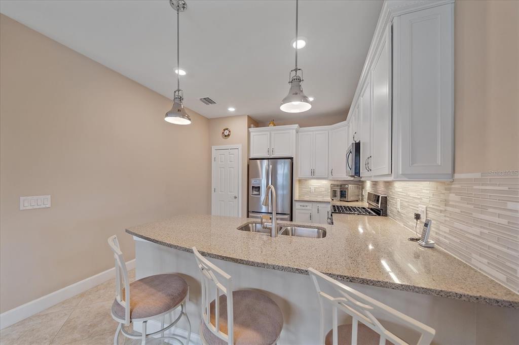 17535 Hampton Falls Terrace Bradenton, FL 34202 - Photo 11 of 41 a kitchen with a sink cabinets and window