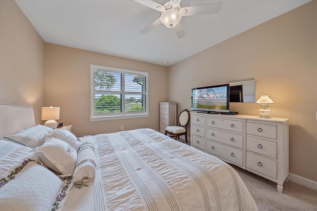 17535 Hampton Falls Terrace Bradenton, FL 34202 - Photo 22 of 41 a bedroom with a bed and a tv on dresser