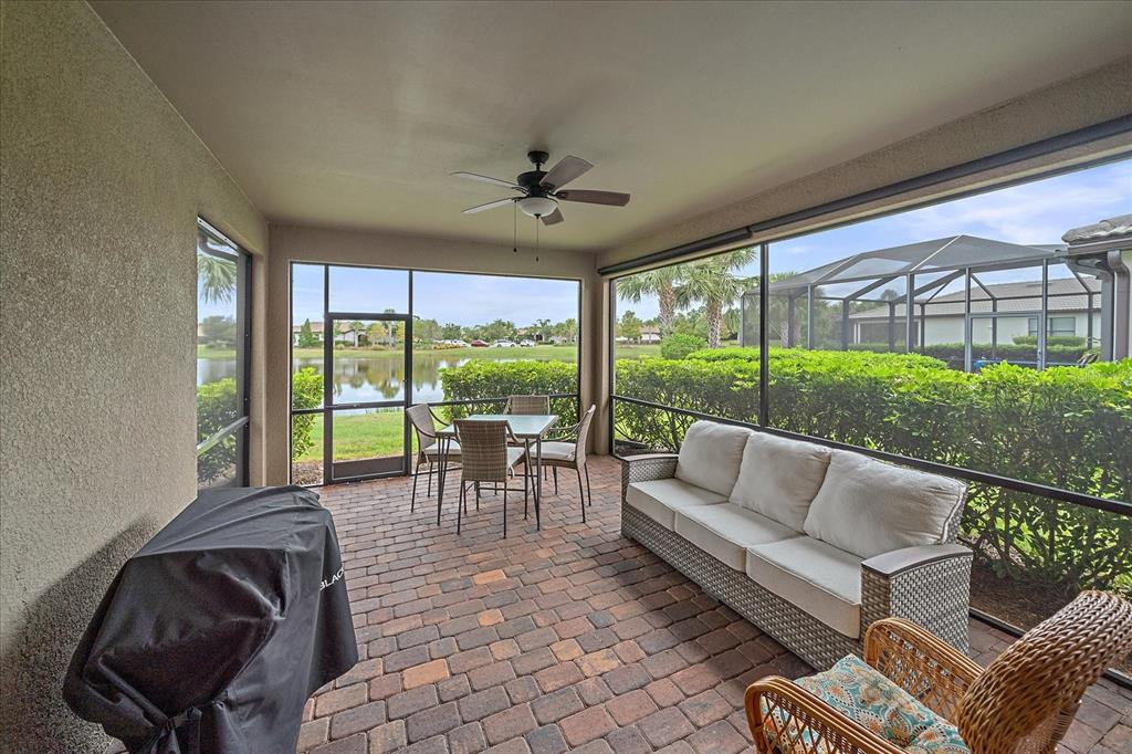 17535 Hampton Falls Terrace Bradenton, FL 34202 - Photo 27 of 41 a living room with furniture and a large window