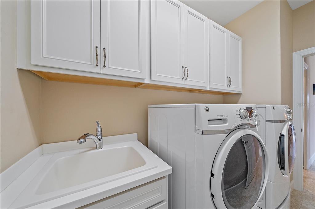 17535 Hampton Falls Terrace Bradenton, FL 34202 - Photo 31 of 41 a bathroom with a sink and a washer dryer
