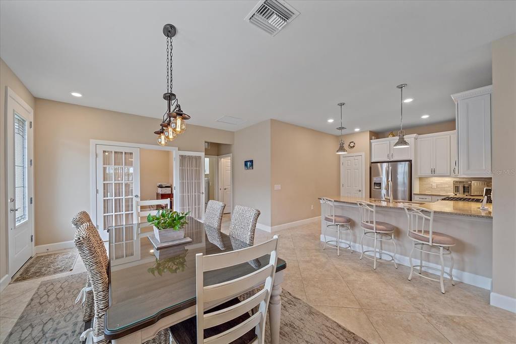17535 Hampton Falls Terrace Bradenton, FL 34202 - Photo 5 of 41 a view of a dining room with furniture