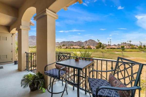 a view of a chairs and table in patio