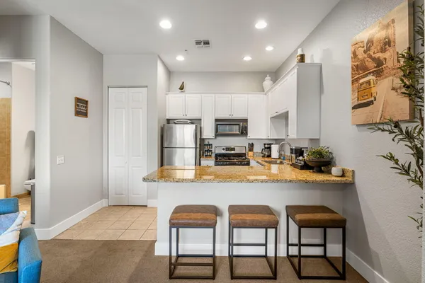 a kitchen with stainless steel appliances granite countertop a stove and refrigerator