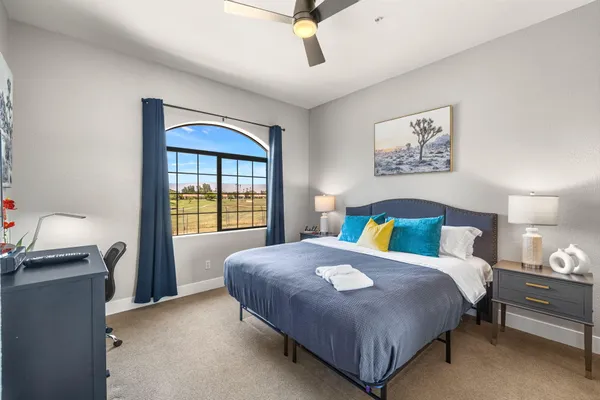 a bedroom with a bed and a window