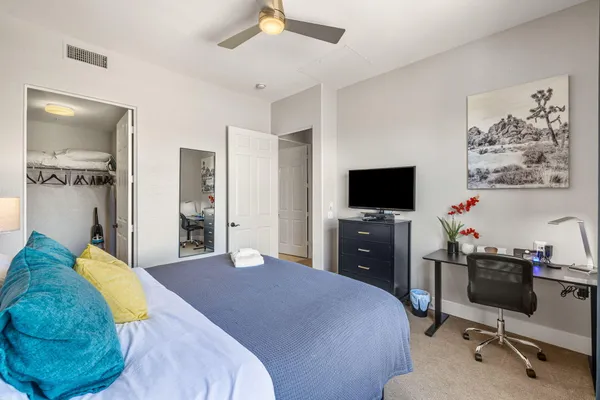a bedroom with a bed and a flat screen tv