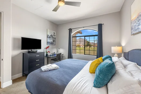 a bedroom with a bed and a flat screen tv