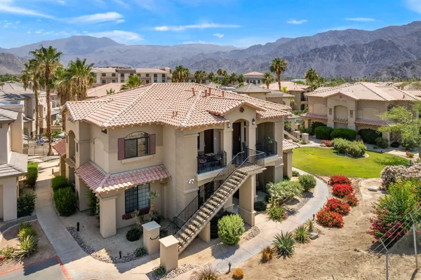 an aerial view of a house with a yard