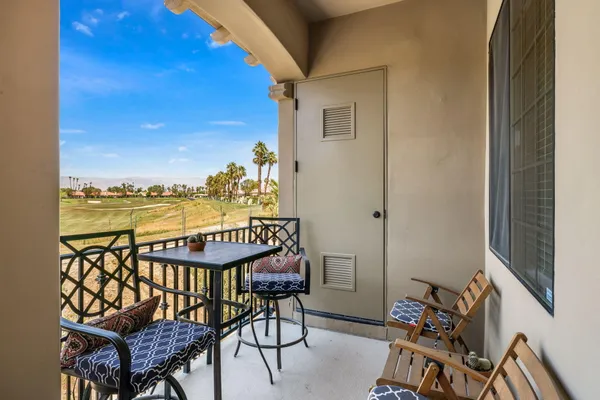 a view of a balcony with an outdoor seating