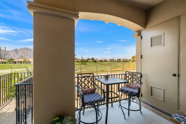 a view of a chairs and table in patio