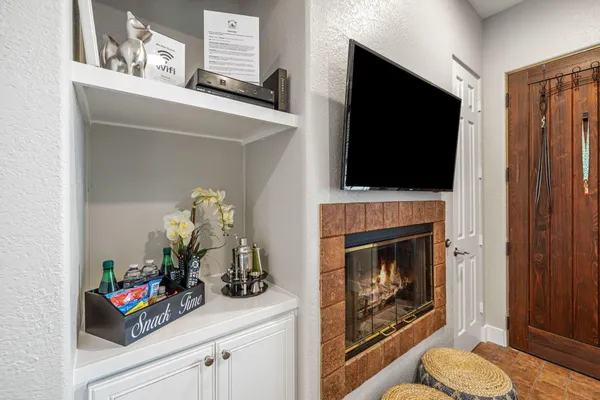 a living room with a fireplace and a flat screen tv