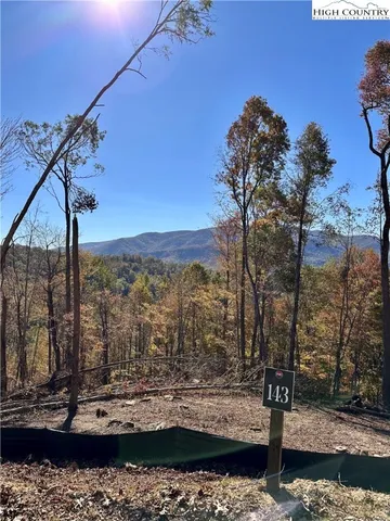 a view of a ocean with a mountain in the background