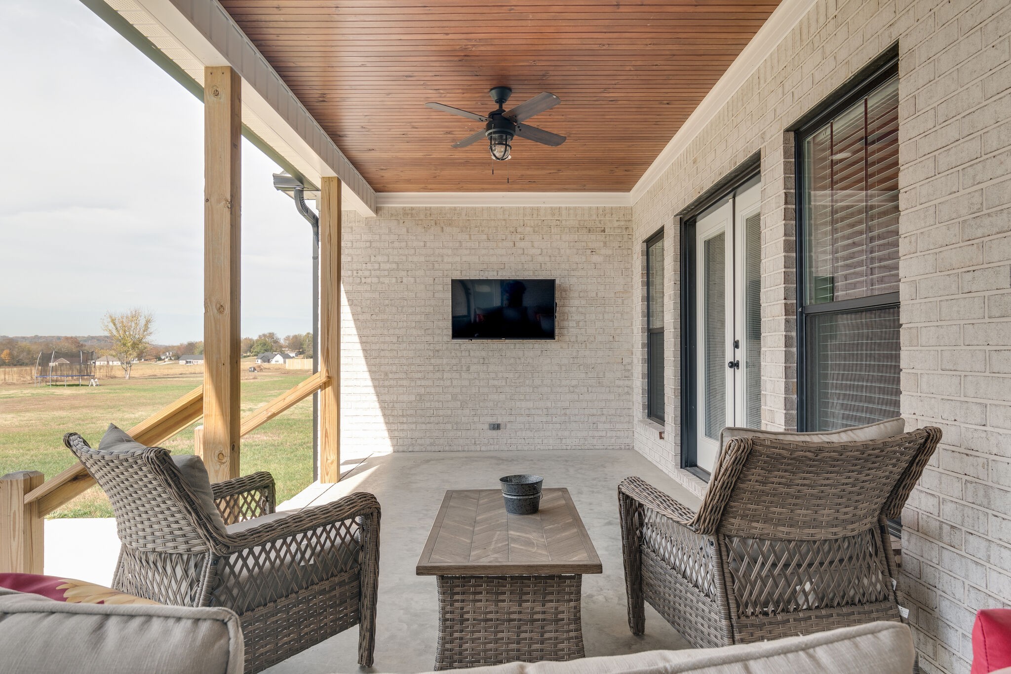 947 South Cross Bridges Road Mount Pleasant, TN 38474 - Photo 36 of 37 a living room with furniture a flat screen tv and a floor to ceiling window