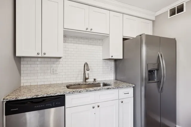 a kitchen with stainless steel appliances granite countertop a refrigerator sink and cabinets