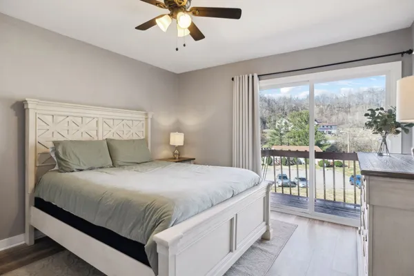 a bedroom with a large bed and a large window