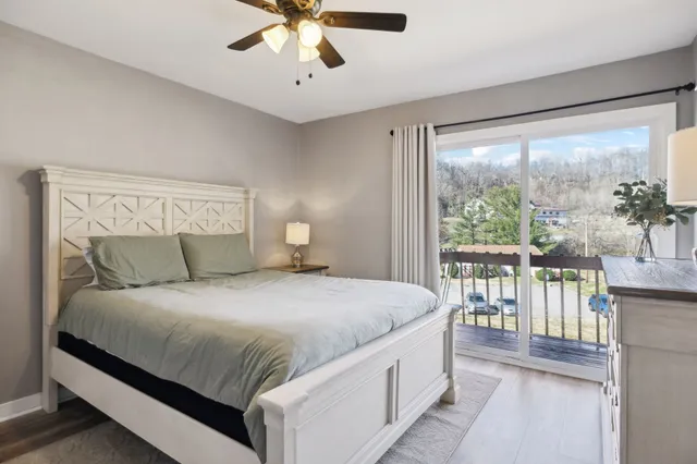 a bedroom with a large bed and a large window