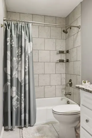 a bathroom with a toilet a sink and shower