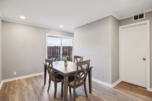 a view of a dining room with furniture and wooden floor