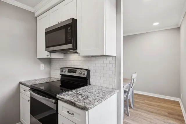 a kitchen with a stove microwave and sink