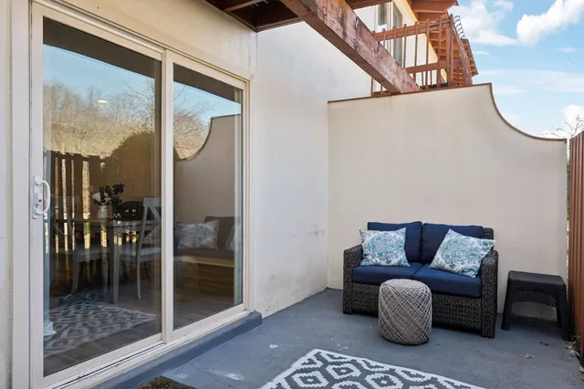 a outdoor living space with furniture and a rug