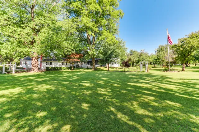a front view of a house with yard and green space