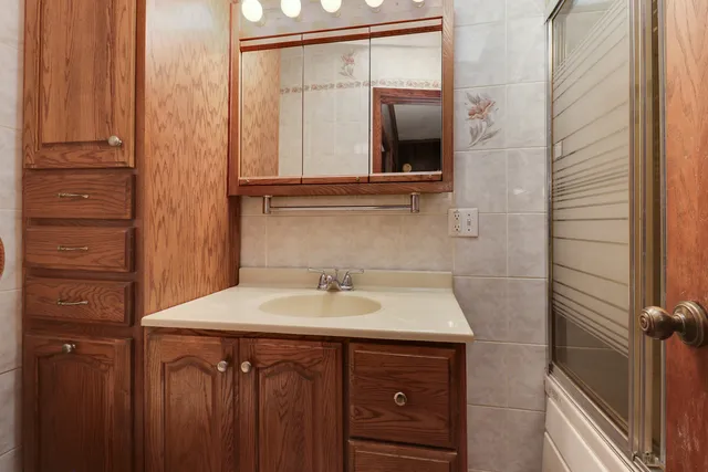 a view of a hallway with wooden shelves