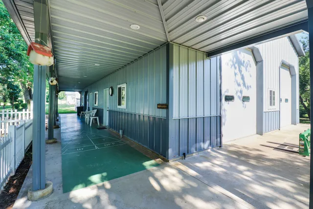 a view of a house with a yard and sitting area