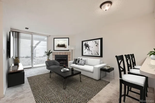 a living room with furniture a fireplace and a table