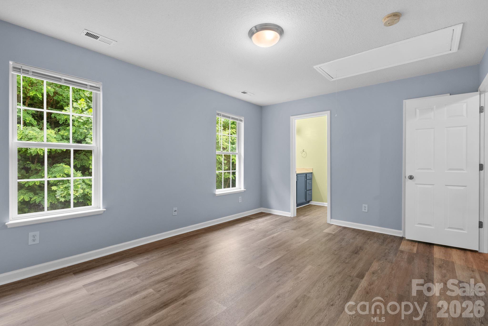 120 Alpine Ridge Drive Asheville, NC 28803 - Photo 17 of 28 an empty room with wooden floor and windows