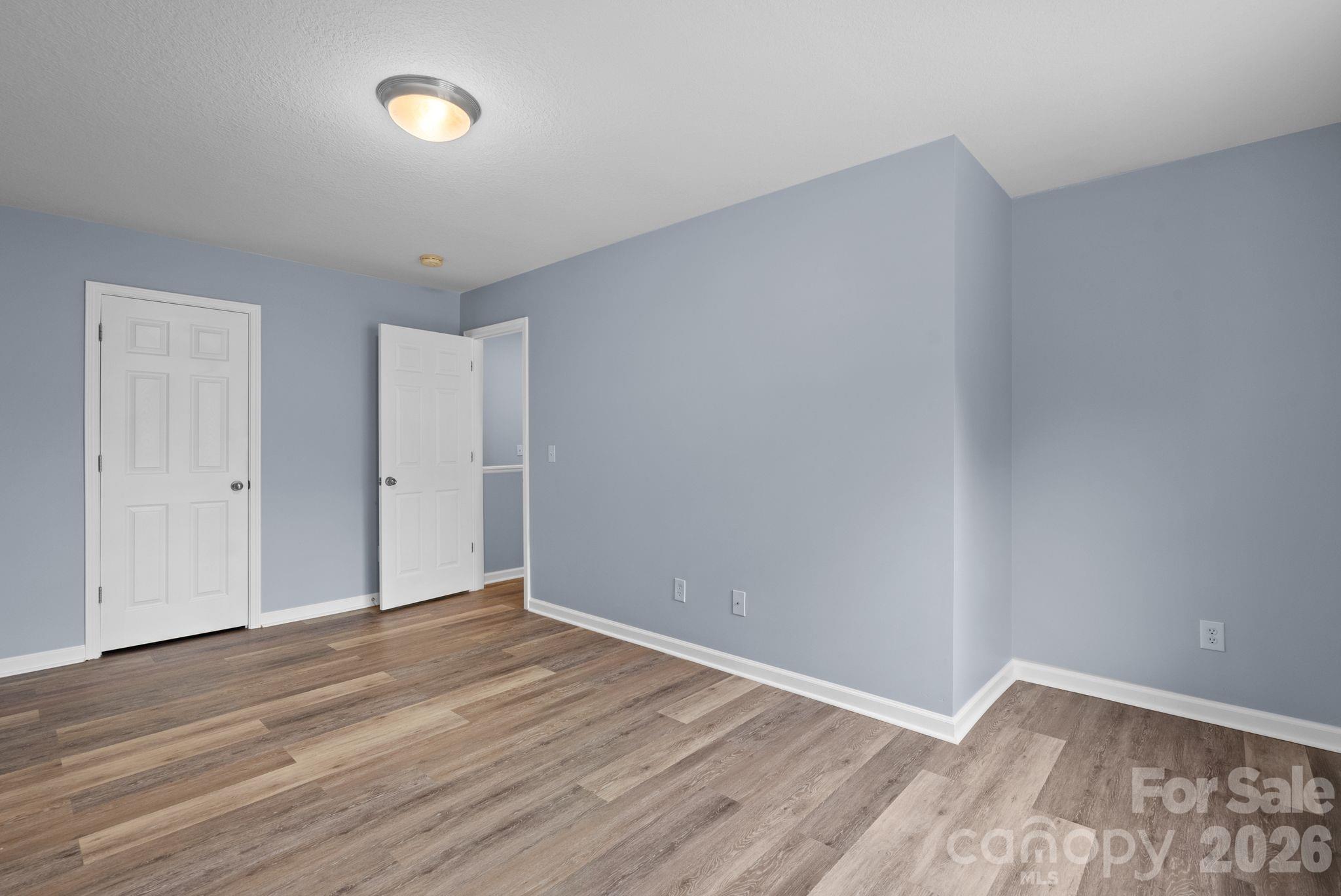 120 Alpine Ridge Drive Asheville, NC 28803 - Photo 23 of 28 a view of an empty room with wooden floor and a window