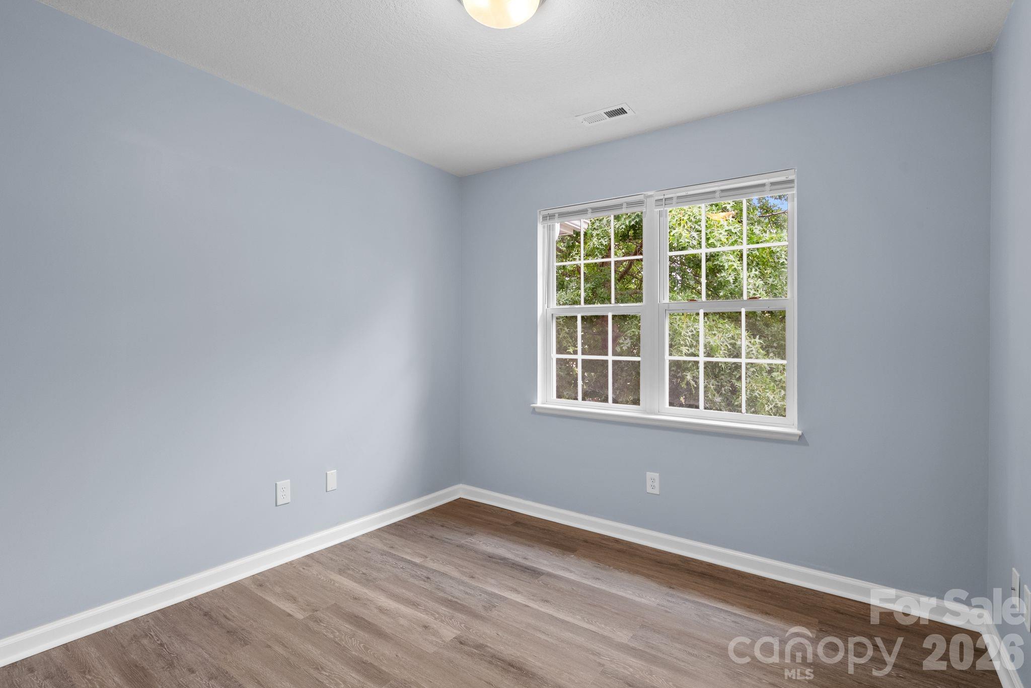 120 Alpine Ridge Drive Asheville, NC 28803 - Photo 25 of 28 an empty room with wooden floor and windows