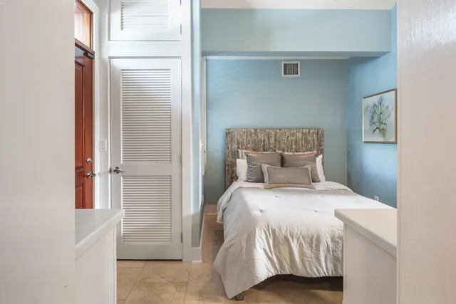 a bedroom with a bed and window