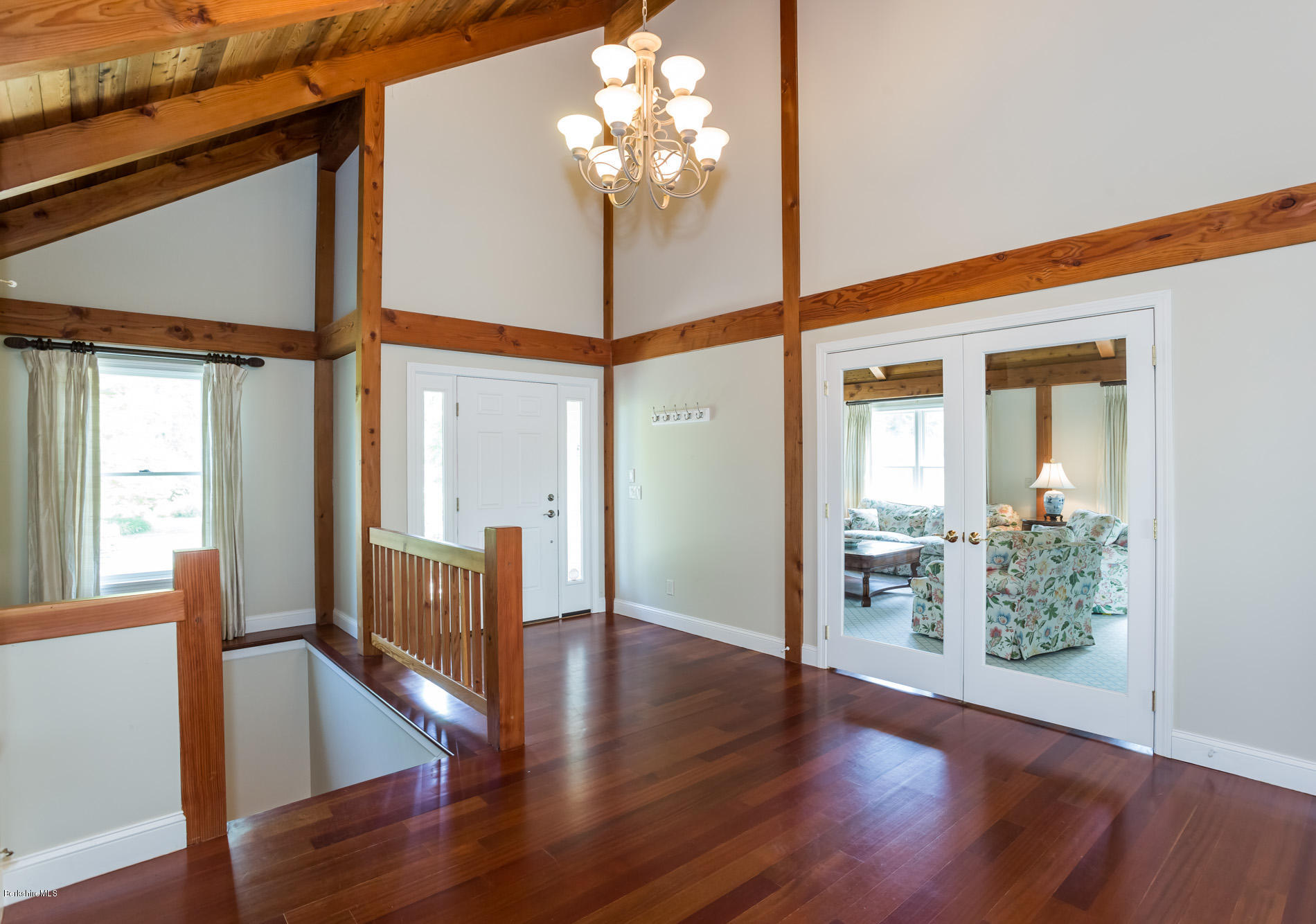 305 Moreau Road Tolland, MA 01034 - Photo 17 of 49 a view of a livingroom with wooden floor and a chandelier